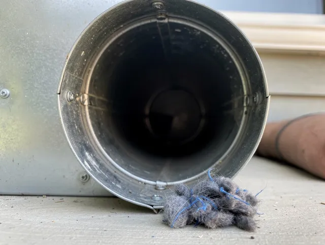 Kannapolis Dryer Vent Cleaning technician using specialized equipment to clear severe dryer vent blockage in Kannapolis
